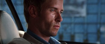 Movie still from “Memento” (2000), directed by Christopher Nolan – A person wearing a shirt and tie; Close Up shot, Low angle