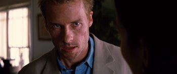Movie still from “Memento” (2000), directed by Christopher Nolan – A person wearing a jacket; Close Up shot, Over the shoulder angle