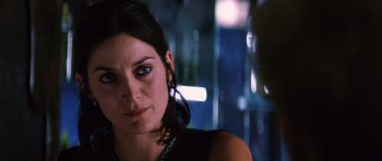 Movie still from “Memento” (2000), directed by Christopher Nolan – A person wearing a black dress; Close Up shot, Over the shoulder angle