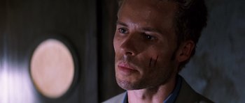 Movie still from “Memento” (2000), directed by Christopher Nolan – A person wearing a shirt and tie; Close Up shot, Low angle
