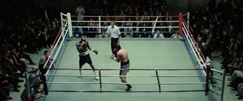 Movie still from “Million Dollar Baby” (2004), directed by Clint Eastwood – Two boxers in a boxing ring during a match; Wide shot, High angle