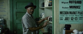 Movie still from “Million Dollar Baby” (2004), directed by Clint Eastwood – An older man in a hat is looking at a shelf; Medium shot, Low angle