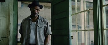 Movie still from “Million Dollar Baby” (2004), directed by Clint Eastwood – A man wearing a hat standing in front of an open door; Close Up shot, Low angle