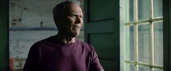 Movie still from “Million Dollar Baby” (2004), directed by Clint Eastwood – An older man wearing a purple shirt is standing in front of a green door; Close Up shot, Low angle
