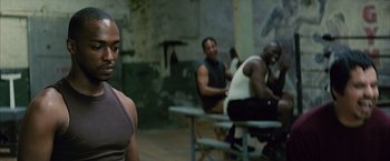 Movie still from “Million Dollar Baby” (2004), directed by Clint Eastwood – A group of men sitting at tables in a room; Close Up shot, Over the shoulder angle