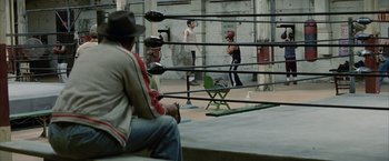 Movie still from “Million Dollar Baby” (2004), directed by Clint Eastwood – A group of people in a boxing ring; Wide shot, High angle