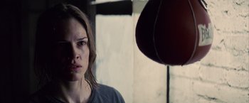 Movie still from “Million Dollar Baby” (2004), directed by Clint Eastwood – A person with a hat; Close Up shot, Over the shoulder angle