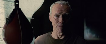 Movie still from “Million Dollar Baby” (2004), directed by Clint Eastwood – An older man with a gray beard and a green eye; Close Up shot, Low angle
