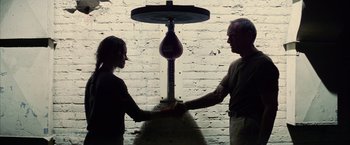 Movie still from “Million Dollar Baby” (2004), directed by Clint Eastwood – A man and a woman holding hands in front of a punching bag; Medium shot, Low angle