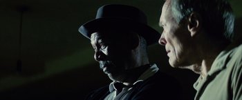 Movie still from “Million Dollar Baby” (2004), directed by Clint Eastwood – A man wearing a black hat and a white shirt; Close Up shot, Low angle