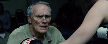 Movie still from “Million Dollar Baby” (2004), directed by Clint Eastwood – An older man is looking at the camera; Close Up shot, Over the shoulder angle
