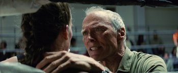 Movie still from “Million Dollar Baby” (2004), directed by Clint Eastwood – An older man looking at a younger man in the mirror; Close Up shot, Over the shoulder angle