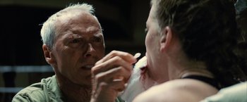 Movie still from “Million Dollar Baby” (2004), directed by Clint Eastwood – An older man is shaving his face in front of a mirror; Close Up shot, Over the shoulder angle