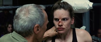 Movie still from “Million Dollar Baby” (2004), directed by Clint Eastwood – An older man and a young woman looking into a mirror; Close Up shot, Over the shoulder angle