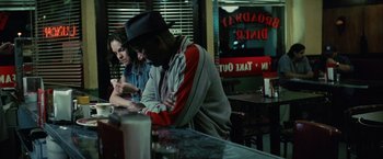 Movie still from “Million Dollar Baby” (2004), directed by Clint Eastwood – A man and a woman sitting at a table in a restaurant; Medium shot, Over the shoulder angle