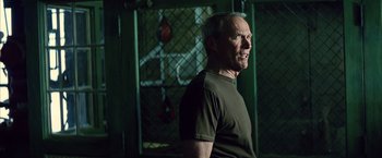 Movie still from “Million Dollar Baby” (2004), directed by Clint Eastwood – An older man standing in front of a punching bag; Close Up shot, Low angle