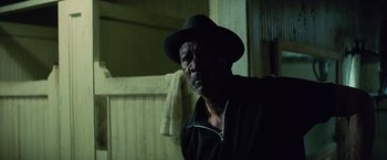 Movie still from “Million Dollar Baby” (2004), directed by Clint Eastwood – An older man wearing a black hat and a black jacket; Close Up shot, Low angle
