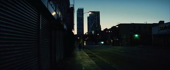 Movie still from “Million Dollar Baby” (2004), directed by Clint Eastwood – A person walking down a street at night; Extreme Wide shot, Low angle