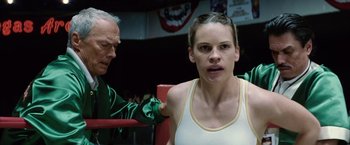 Movie still from “Million Dollar Baby” (2004), directed by Clint Eastwood – A woman sitting in a boxing ring with a trainer; Close Up shot, Over the shoulder angle