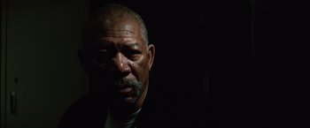 Movie still from “Million Dollar Baby” (2004), directed by Clint Eastwood – An older man in a suit and tie looking at the camera; Close Up shot, Low angle