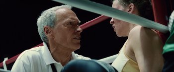 Movie still from “Million Dollar Baby” (2004), directed by Clint Eastwood – Two men in a boxing ring facing each other; Close Up shot, Over the shoulder angle