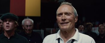 Movie still from “Million Dollar Baby” (2004), directed by Clint Eastwood – An older man smiling for the camera with another older man in the background; Close Up shot, Low angle
