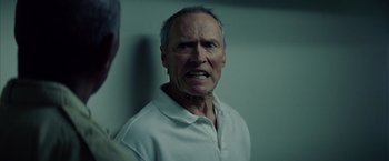 Movie still from “Million Dollar Baby” (2004), directed by Clint Eastwood – An older man with a frowning look on his face; Close Up shot, Low angle