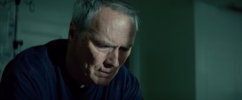 Movie still from “Million Dollar Baby” (2004), directed by Clint Eastwood – An older man looking down at his face; Close Up shot, Low angle