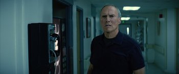 Movie still from “Million Dollar Baby” (2004), directed by Clint Eastwood – An older man standing in a room with a camera; Close Up shot, Low angle