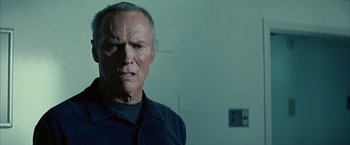 Movie still from “Million Dollar Baby” (2004), directed by Clint Eastwood – An older man in a black shirt is looking at the camera; Close Up shot, Low angle