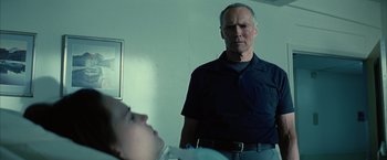 Movie still from “Million Dollar Baby” (2004), directed by Clint Eastwood – An older man standing in front of a young woman; Medium shot, Over the shoulder angle