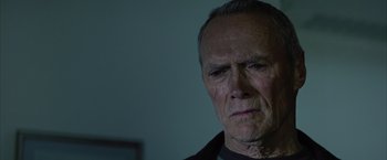Movie still from “Million Dollar Baby” (2004), directed by Clint Eastwood – An old man with a sad look on his face; Close Up shot, Low angle