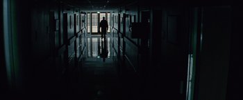 Movie still from “Million Dollar Baby” (2004), directed by Clint Eastwood – A man walking down a hallway in a building; Wide shot, Low angle