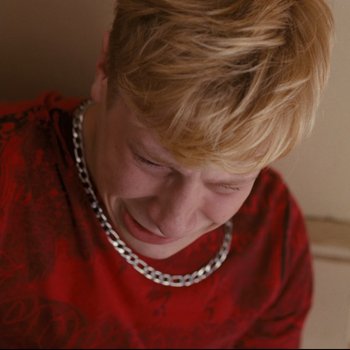 Movie still from “Mommy” (2014), directed by Xavier Dolan – A person wearing a necklace; Close Up shot, High angle