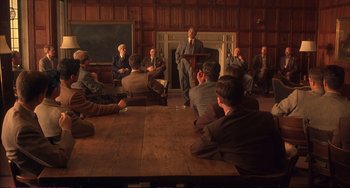 Movie still from “A Beautiful Mind” (2001), directed by Ron Howard – A group of people sitting around a room; Wide shot, High angle