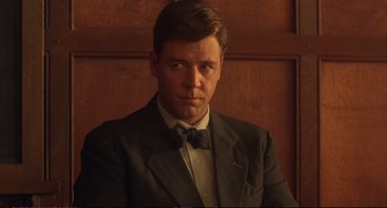 Movie still from “A Beautiful Mind” (2001), directed by Ron Howard – A person wearing a suit and bow tie; Close Up shot, Low angle