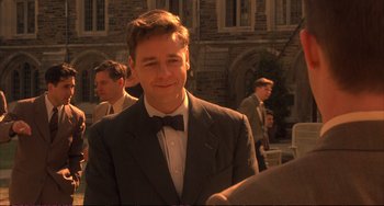 Movie still from “A Beautiful Mind” (2001), directed by Ron Howard – A man wearing a suit and bow tie; Close Up shot, Over the shoulder angle