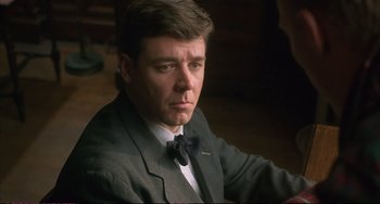 Movie still from “A Beautiful Mind” (2001), directed by Ron Howard – A person wearing a suit and tie; Close Up shot, Low angle