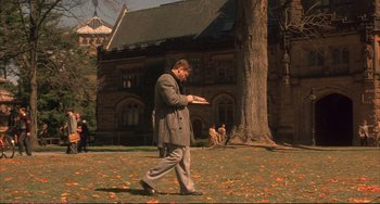 Movie still from “A Beautiful Mind” (2001), directed by Ron Howard – A man walking across a grass covered field; Wide shot, High angle