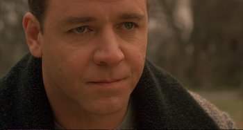 Movie still from “A Beautiful Mind” (2001), directed by Ron Howard – A man's face in a black jacket; Close Up shot, Over the shoulder angle