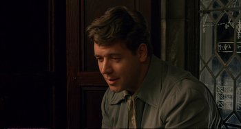 Movie still from “A Beautiful Mind” (2001), directed by Ron Howard – A young man in a shirt and tie looking to his left; Close Up shot, Over the shoulder angle