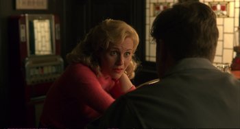 Movie still from “A Beautiful Mind” (2001), directed by Ron Howard – A woman sitting next to a man in a room; Close Up shot, Over the shoulder angle