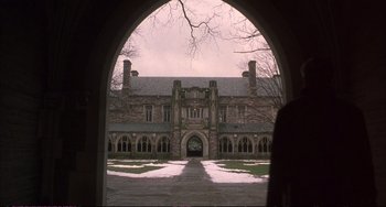 Movie still from “A Beautiful Mind” (2001), directed by Ron Howard – An archway leading to a building with a large stone facade; Extreme Wide shot, Low angle