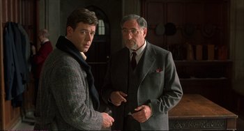 Movie still from “A Beautiful Mind” (2001), directed by Ron Howard – Two men standing next to each other in a room; Medium shot, Over the shoulder angle