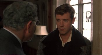 Movie still from “A Beautiful Mind” (2001), directed by Ron Howard – A man is looking at another man in a room; Close Up shot, Over the shoulder angle