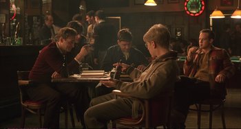 Movie still from “A Beautiful Mind” (2001), directed by Ron Howard – A group of people sitting around a table; Wide shot, High angle
