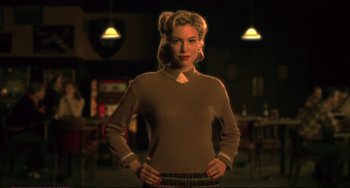 Movie still from “A Beautiful Mind” (2001), directed by Ron Howard – A woman standing in front of a table in a restaurant; Medium shot, Low angle