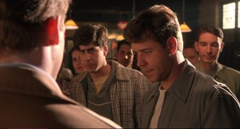 Movie still from “A Beautiful Mind” (2001), directed by Ron Howard – A group of men standing next to each other in a room; Medium shot, Over the shoulder angle