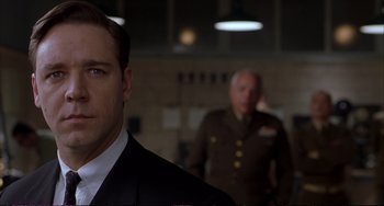 Movie still from “A Beautiful Mind” (2001), directed by Ron Howard – A man in a military uniform standing next to another man in a uniform; Close Up shot, Low angle
