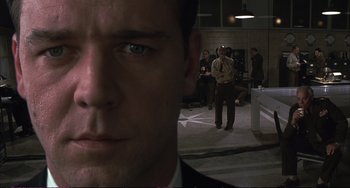 Movie still from “A Beautiful Mind” (2001), directed by Ron Howard – A man in a suit and tie; Close Up shot, Low angle